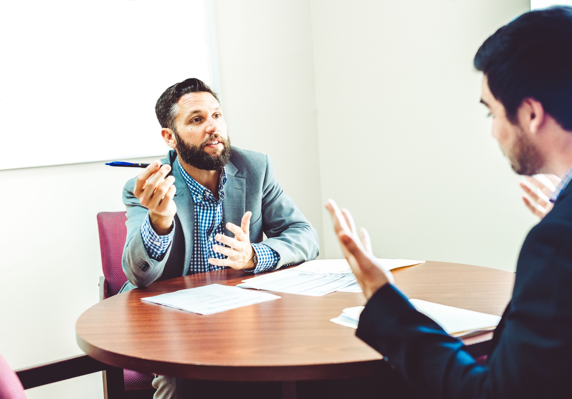 Two businessmen in suits have a serious or difficult discussion meeting in an office